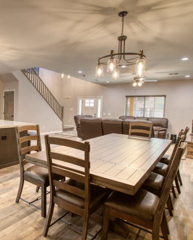 Modern dining room with wooden table and chairs.