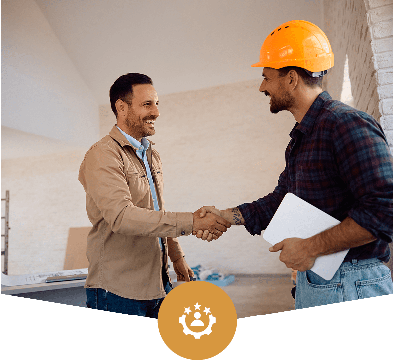 Contractor and client shaking hands indoors.